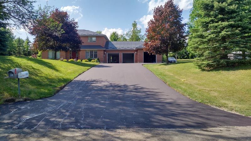 Long residential driveway with fresh sealcoat